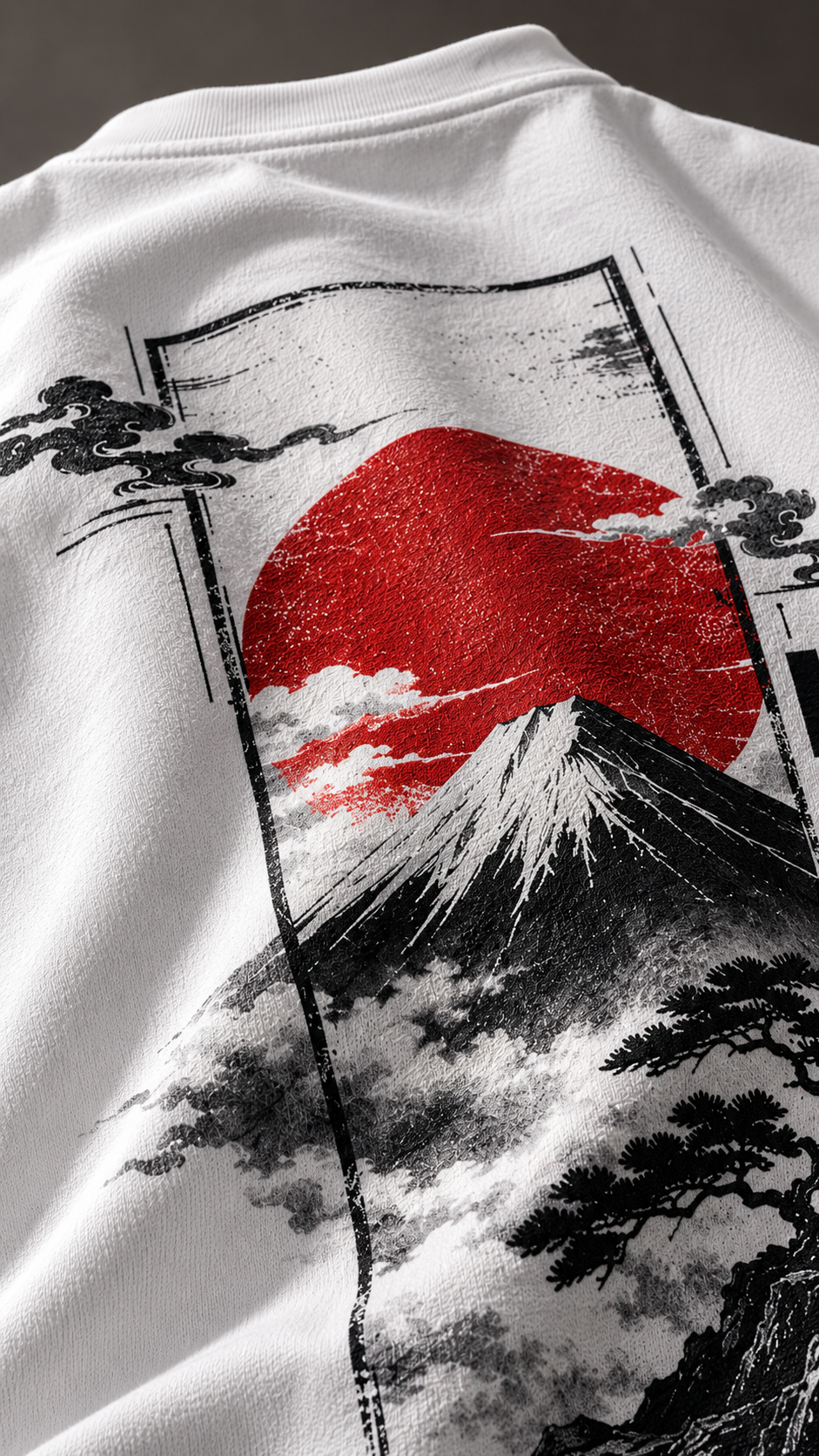 Close-up of a white sweatshirt featuring a large graphic print of Mount Fuji with a red sun and black clouds in a Japanese-style frame.